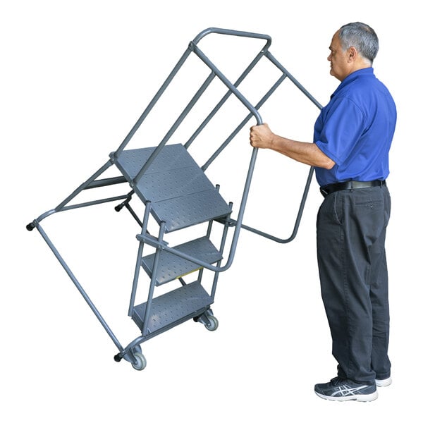 A man standing next to a Ballymore steel rolling ladder.