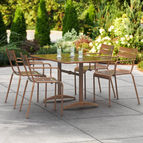 A brown powder-coated aluminum Lancaster Table & Seating outdoor dining table with 4 chairs and drinks on a patio.
