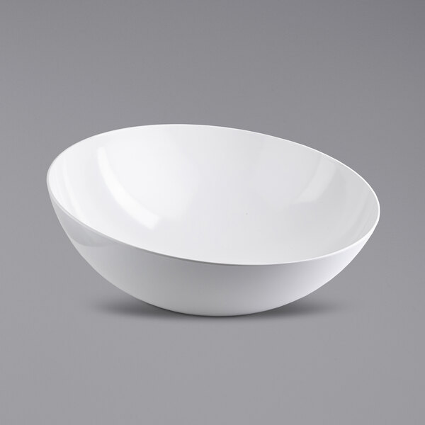 A Tablecraft Sierra Grande white melamine serving bowl on a gray surface.