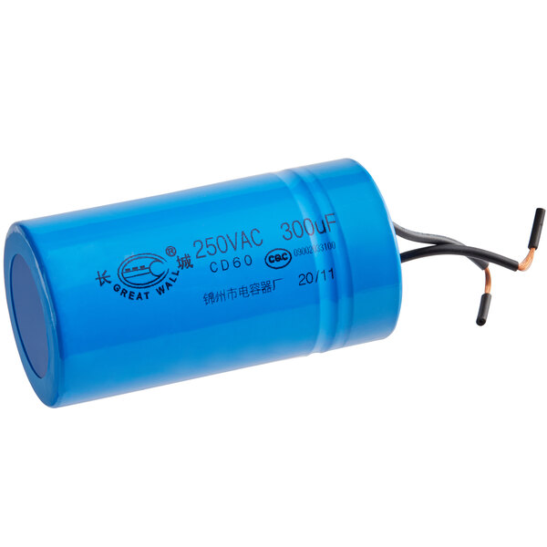 A blue Estella starting capacitor with black text and wires.
