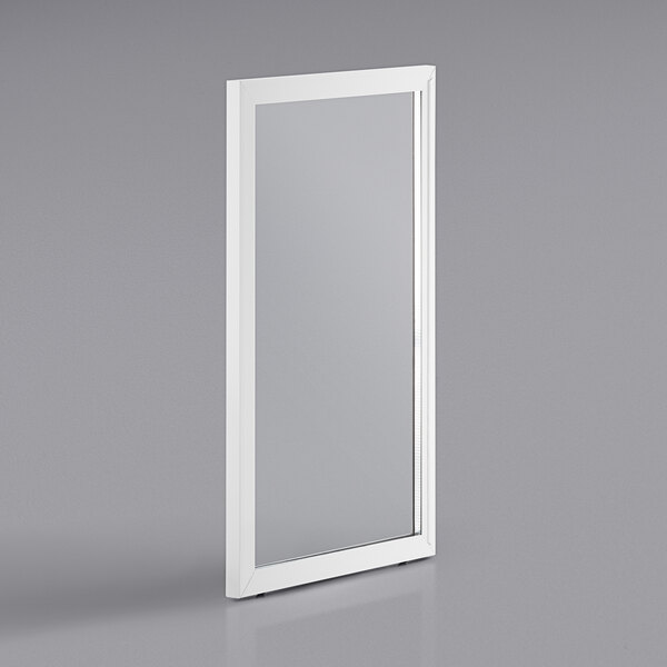 a white rectangular mirror on a grey surface