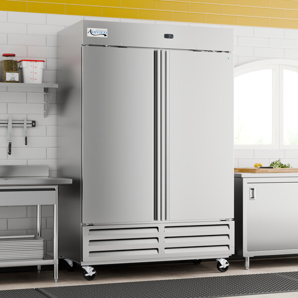 A large stainless steel solid door reach-in refrigerator with double doors and caster wheels, designed for commercial kitchens.