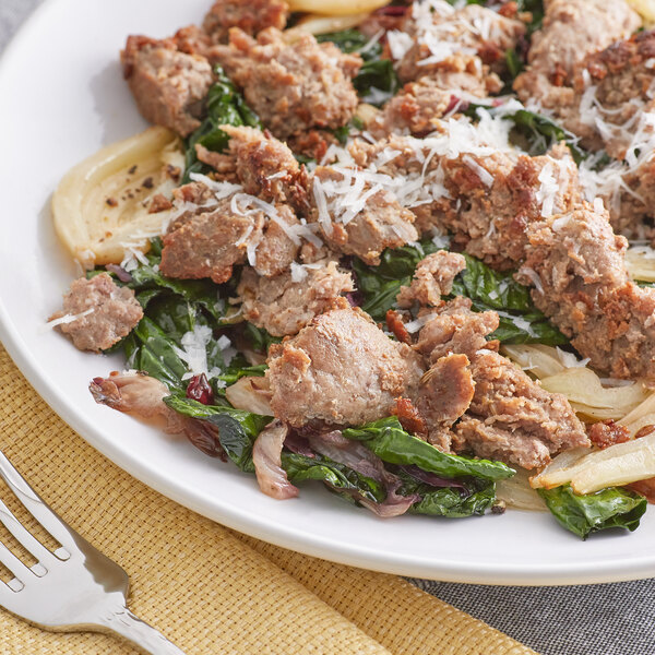 A plate of pasta with Warrington Farm Meats Sweet Italian Turkey Sausage and spinach on it.