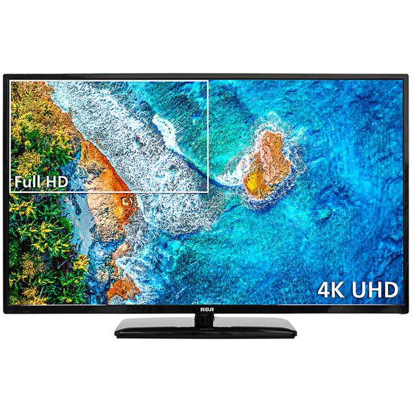An RCA PT Series 4K Pro:Idiom Hospitality HD television screen showing an aerial view of a beach and mountains.