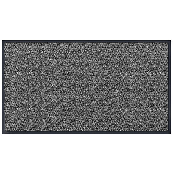 A grey rectangular door mat with a chevron pattern in black.