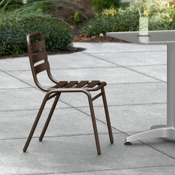 A Lancaster Table & Seating bronze outdoor side chair on a table.