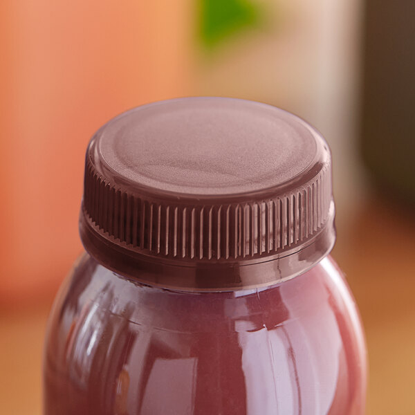 A plastic bottle of juice with a brown tamper-evident cap.