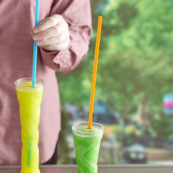 A person holding a pair of plastic cups with Choice neon straws in them.