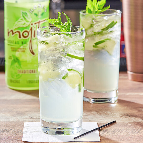 A glass of Rose's Mojito Mix with ice and mint leaves.