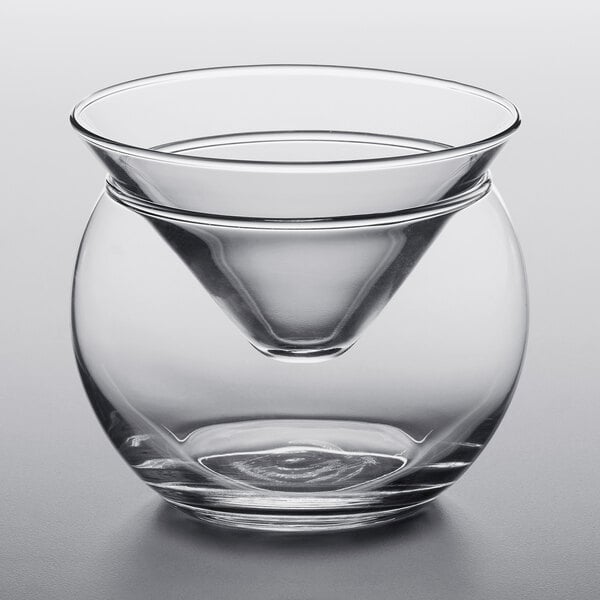 A clear glass bowl with a cone inside for caviar.