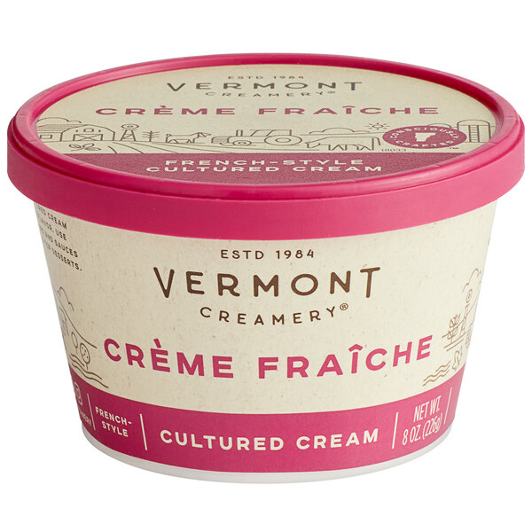 A container of Vermont Creamery Creme Fraiche with a red lid.