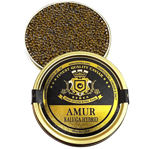A round metal container of Bemka Amur Kaluga Hybrid Sturgeon Caviar with a black and gold label.