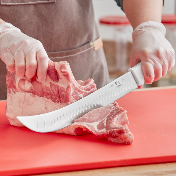A person cutting meat with a Choice cimeter knife.