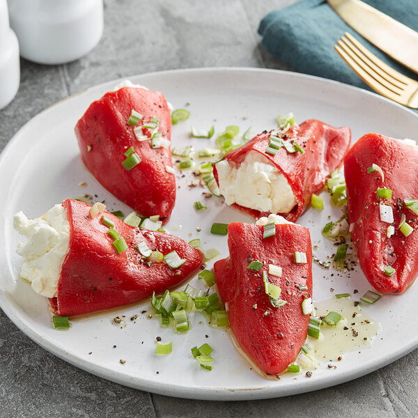 A plate with Del Destino roasted red peppers stuffed with white cream and green onions.