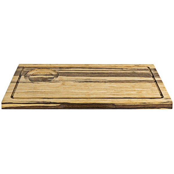 A Front of the House reversible wooden serving board with hand grips and a circle design carved into it.