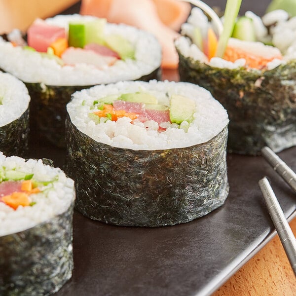 A plate of sushi rolls with Full Sheet Green Seaweed Sushi Nori.