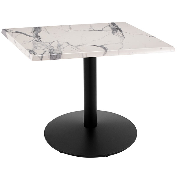 A white marble square table top on a black round pedestal.