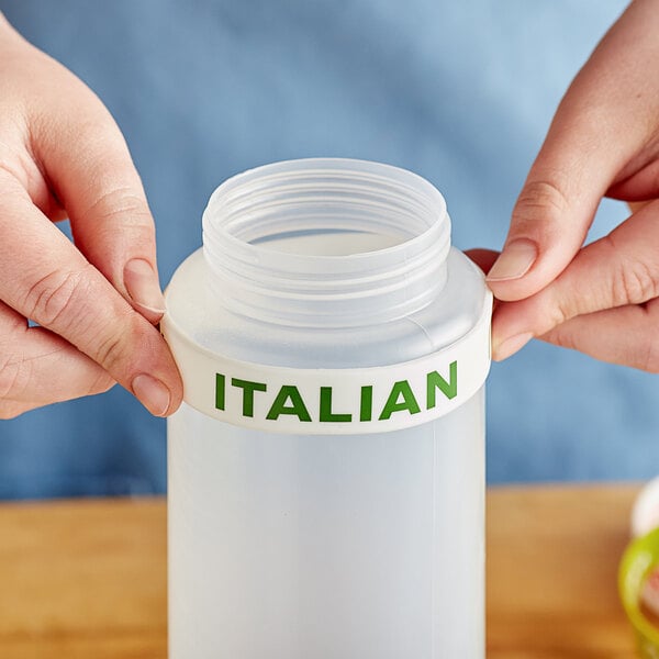 A person using an Italian label band on a plastic squeeze bottle.
