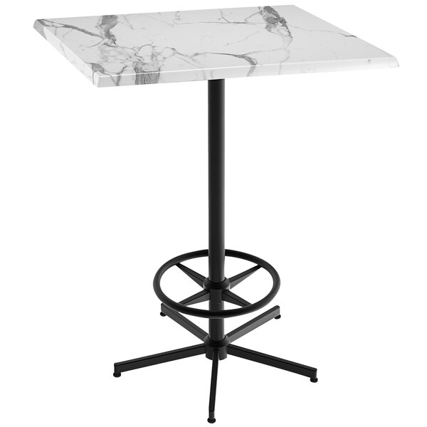 A white marble Holland Bar Table with a black foot rest base.