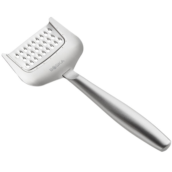 A close-up of a silver Boska stainless steel cheese grater.