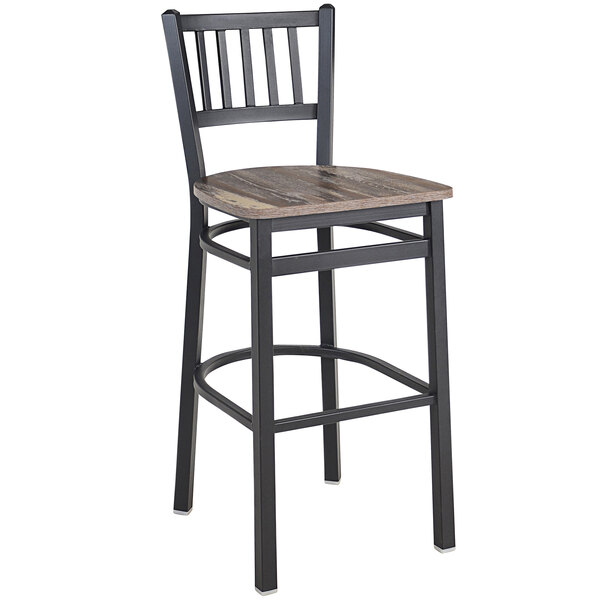 A BFM Seating black steel slat back barstool with a wood seat.