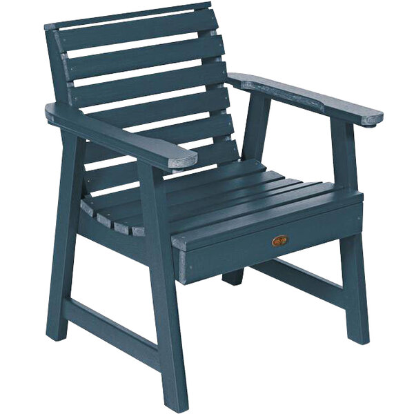 A Nantucket blue outdoor arm chair with a faux wood seat.