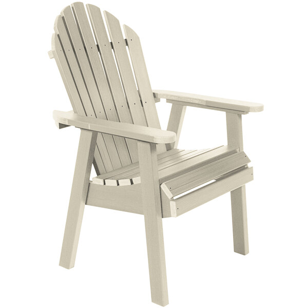 A white faux wood Adirondack dining chair with wooden armrests.