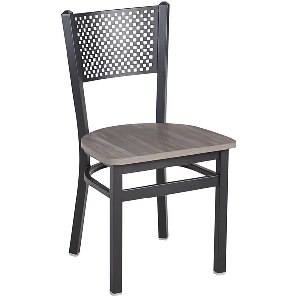 A BFM Seating black steel chair with a wooden seat and perforated back.
