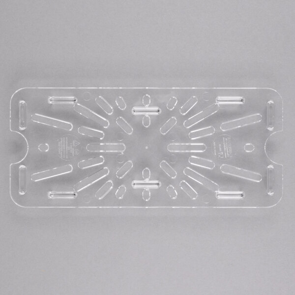 A clear plastic Carlisle 1/3 size drain tray with holes in it.