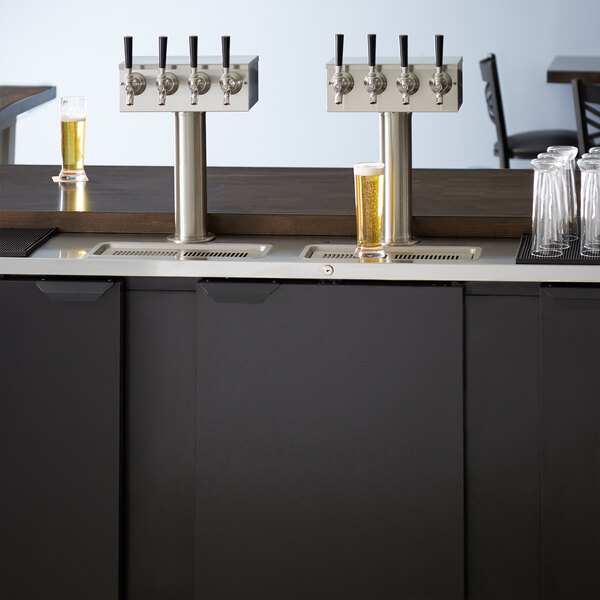 A Beverage-Air kegerator with four wine taps on a counter.