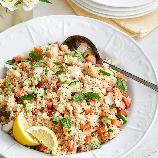 A white bowl of Bob's Red Mill Golden Bulgur Wheat with a lemon wedge.