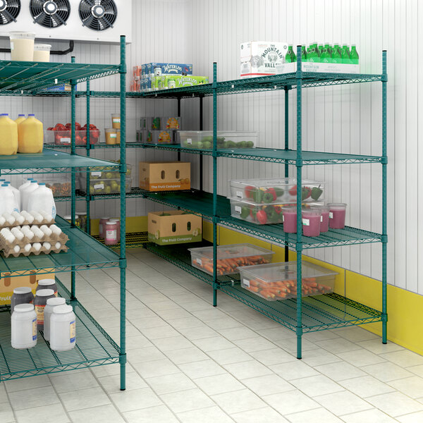 A green metal Regency wire shelving unit with four tiers of food items.