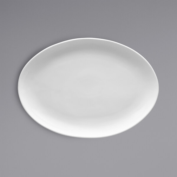 A white oval Fortessa china platter on a gray background.
