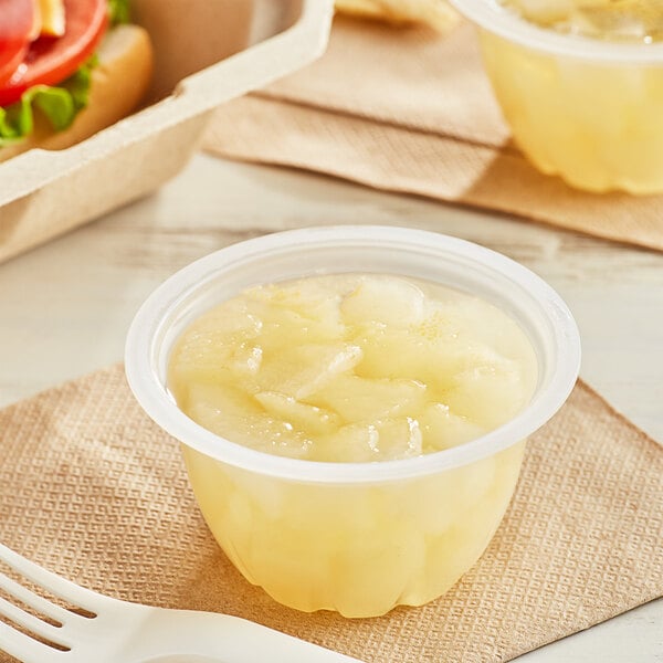 A plastic container of diced pears in natural juice.
