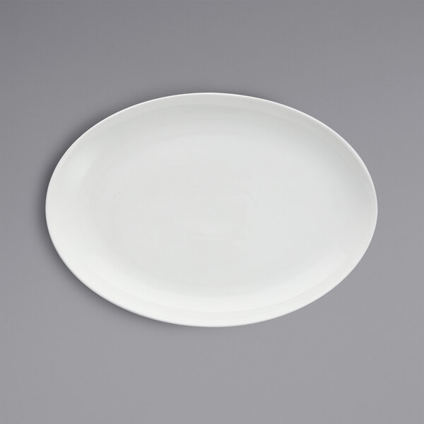 A white Fortessa oval china platter on a gray surface.