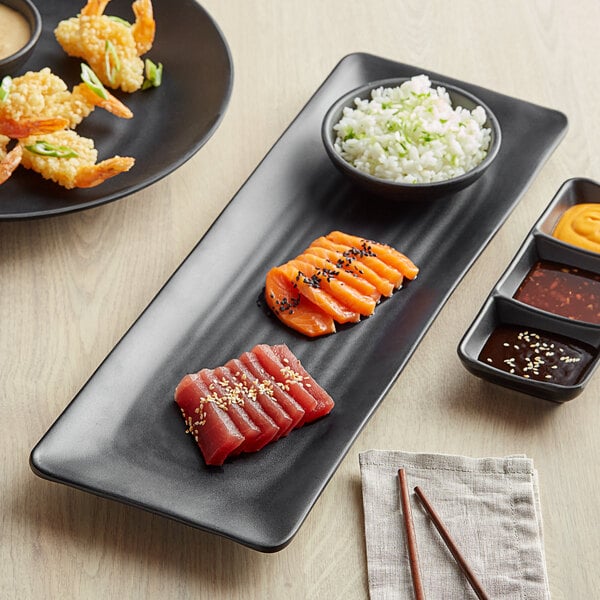 A black GET Nara rectangular melamine platter with sushi, shrimp and other food on a table.