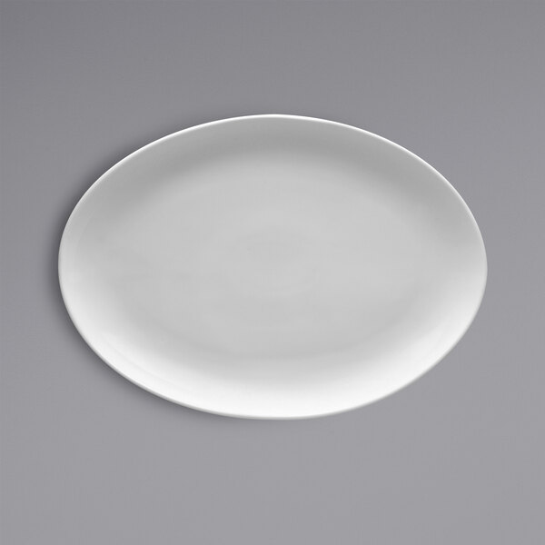 A white oval Fortessa china platter on a gray background.