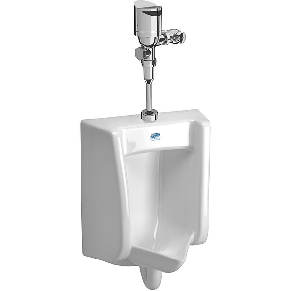 A white Zurn wall hung urinal with a silver top mount flush valve.
