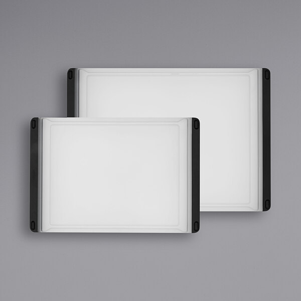 A white rectangular OXO cutting board set with black trim.