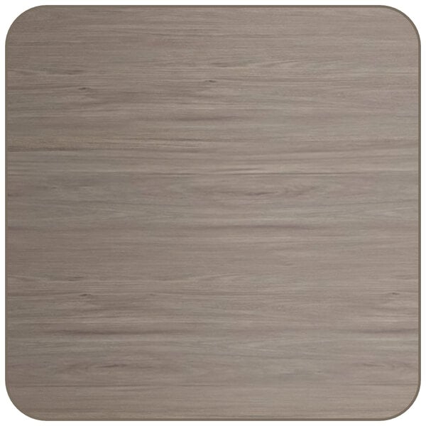 A close-up of a square Lancaster Table & Seating wood table top with a white border and gray and white wood grain.