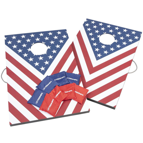A pair of red, white, and blue American flag cornhole boards with bean bags.