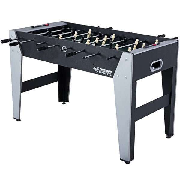 A Triumph foosball table with white and black legs.