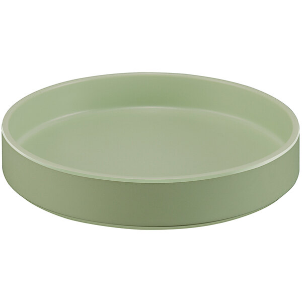 A round green melamine plate with a raised rim.
