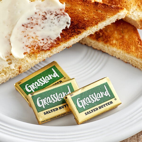 A plate with a piece of toast with Grassland butter on it.