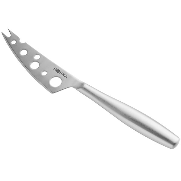 A silver Boska stainless steel cheese knife with holes on the handle.