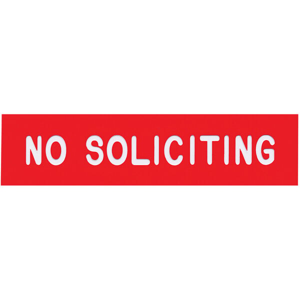 A red sign with white text that says "No Soliciting"