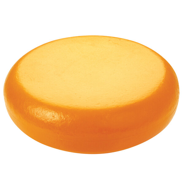 A dark yellow round Boska Gouda cheese replica on a white background.