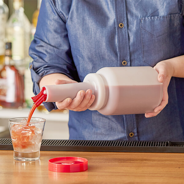 A man using a Choice pour bottle to make a drink.