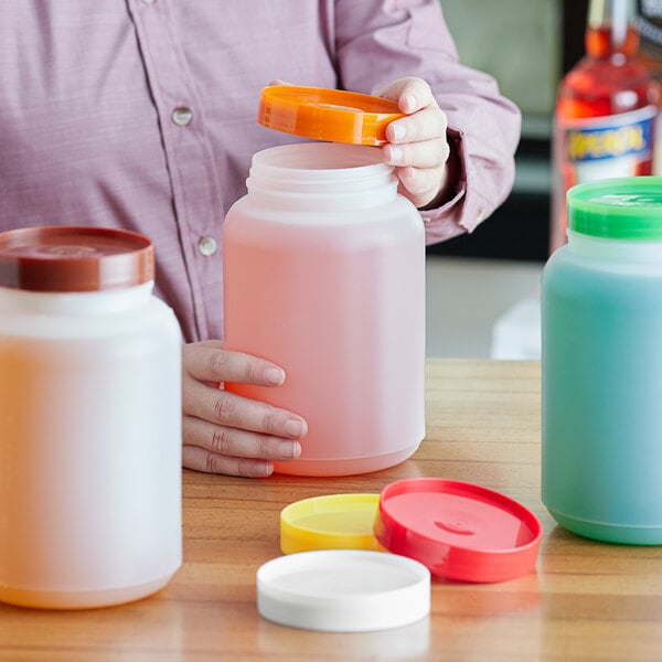 A woman holding Choice plastic containers with different colored lids.