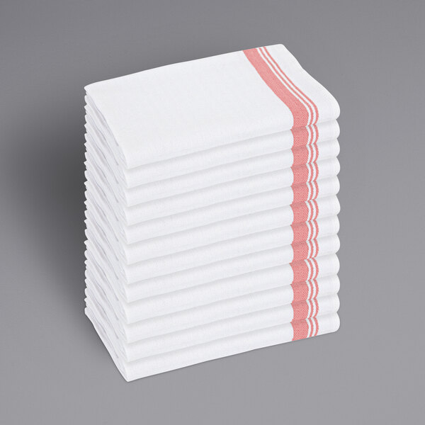 A stack of white Monarch Brands kitchen towels with red stripes.